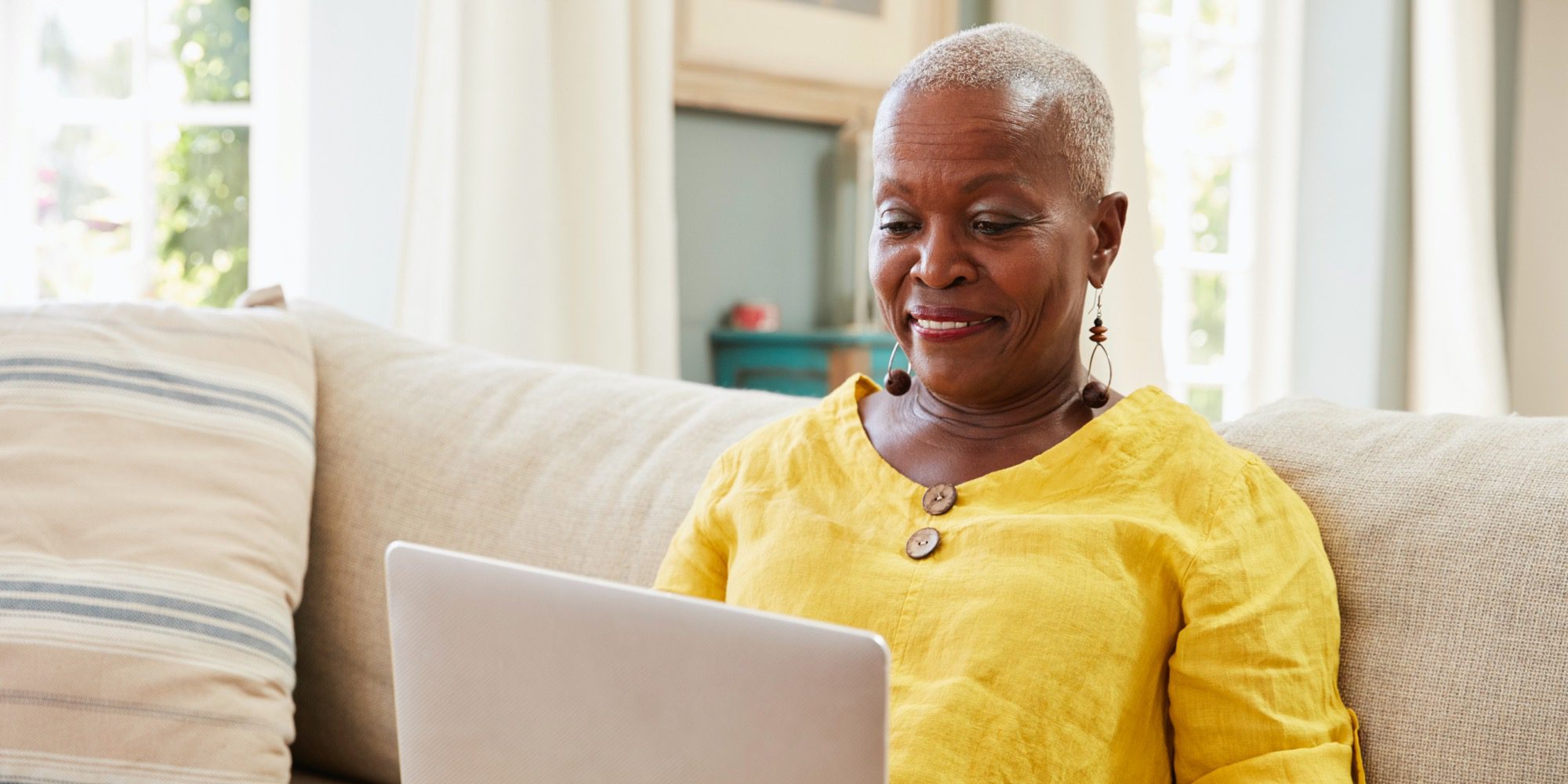 Middle-aged woman browsing healthcare website on laptop